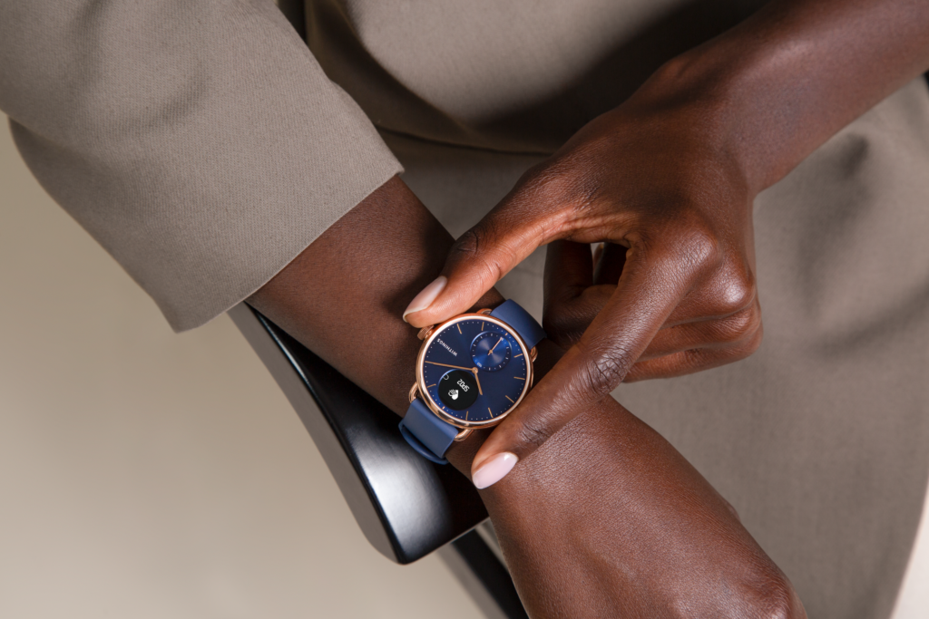 A woman's arm with a blue Withings scanwatch